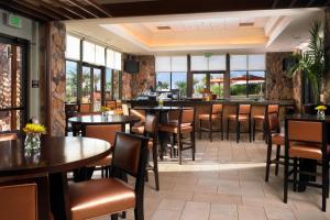 a restaurant with tables and chairs and a bar at The Westin Desert Willow Villas, Palm Desert in Palm Desert