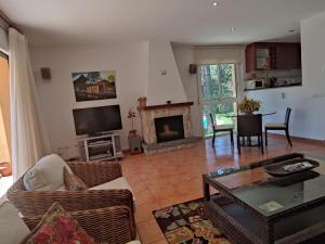 a living room with a couch and a fireplace at VILLAS COSETTE CAMI DE LES PENYES Con piscina y wifi en Sant Feliu de Guíxols - ES-209-80 in Sant Feliu de Guixols