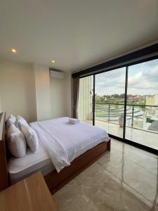 a bedroom with a bed and a large window at Penthouse Berawa - Canggu in Canggu +142 photos