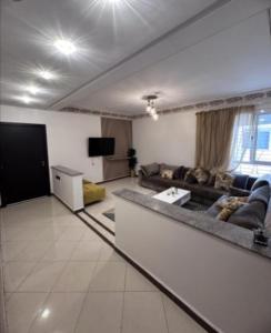 a large living room with a couch and a tv at إخامن in Khenifra