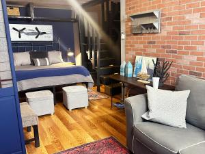 a bedroom with a bed and a brick wall at Neptune's Cottage in Galveston