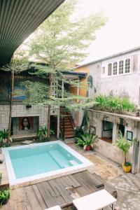 a swimming pool in the yard of a house at The Flying Fish Hostel Cebu in Cebu City