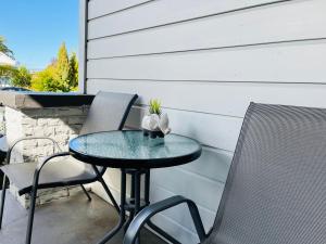 a small table and chairs on a patio at Lux Studio in Dunedin Central in Dunedin