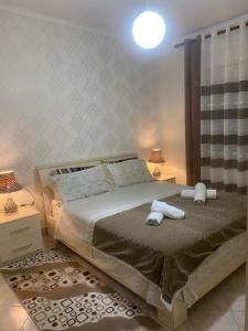 a bedroom with a bed with two towels on it at apartment in the city center in Durrës