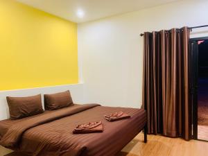 Katil atau katil-katil dalam bilik di Suanvadee Resort สวนวดี รีสอร์ท