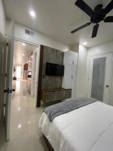 a bedroom with a bed and a ceiling fan at Huichol in Mexicali