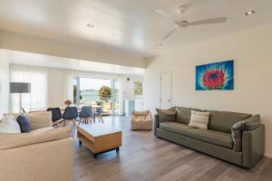 a living room with a couch and a table at Seabeds in Paihia +25 photos
