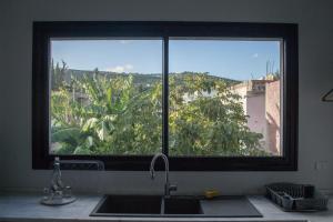 a kitchen window with a sink and a view at Nouvel Appartement Moderne À La Corniche De Bizerte in Bizerte