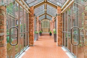 a brick building with a brick hallway with windows at Chic CBD Studio in Heritage House with Pool & BBQ in Melbourne