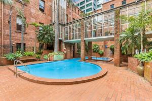 a large swimming pool in front of a building at Chic CBD Studio in Heritage House with Pool & BBQ in Melbourne