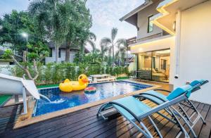 a swimming pool with a rubber duck in a backyard at Luxury 250sqm Pool Villa in Central Location 5min to Beach & Walking Street! in Pattaya Central