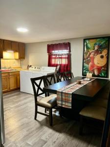 a kitchen with a table and chairs and a dining room at Convenient 2BR/3BD pet friendly Apartment with private entrance in Chicopee