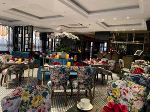 a restaurant with tables and chairs in a room at Golden Silk Boutique Hotel in Hanoi
