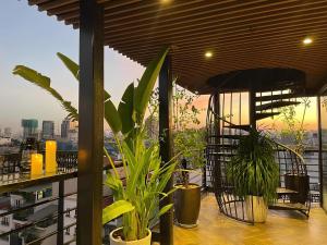 a balcony with plants and a view of a city at Golden Silk Boutique Hotel in Hanoi