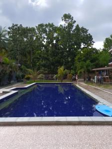 una gran piscina azul en un patio en Kuta Lodge Homestay, en Kuta Lombok