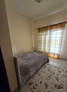 a bedroom with a bed and a window at Great lagoon view 1 bedroom Flat in Ras al Khaimah