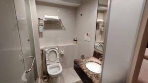 a small bathroom with a toilet and a sink at SUN GARDEN Studio and Residences at South China Sea Place Suites in Kota Kinabalu