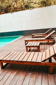 three picnic tables on a wooden deck next to a pool at Kandyan View Holiday Bungalow ''Free Pickup From Kandy city'' in Kandy