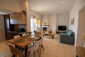 a kitchen and living room with a table and chairs at Uranya in Skiathos