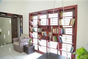a room with a book shelf filled with books at raison d'être - The Residential Library in Trivandrum