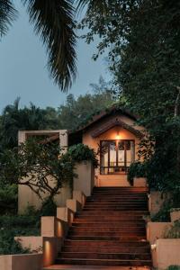 a set of stairs leading up to a house at Sai Vishram Beach Resort in Baindūru