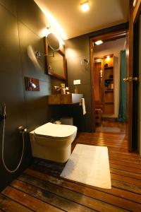 a bathroom with a toilet and a mirror at Little Chembaka in Kumarakom
