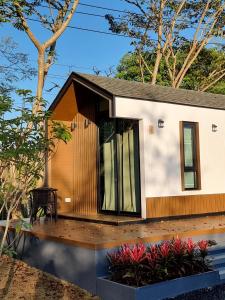 a small house with a wooden deck at Charlee Khaoyai in Mu Si