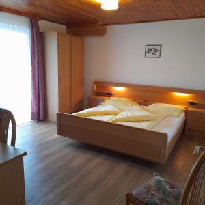 a bedroom with a large bed in a room at Haus Evi in Termeno +6 photos
