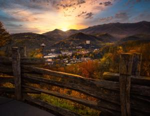 a view of a town from a fence with the sunset at Sonshine By The Stream, Next To A Stream, 560 FREE tickets each paid day in Cosby +14 photos