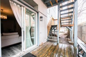 a porch of a house with a sliding glass door at Urban Staycation In The Heart Of Downtown PTBO in Peterborough
