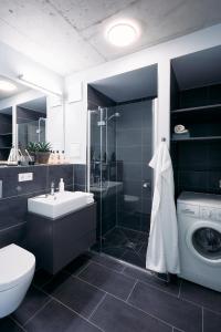 a bathroom with a toilet sink and a washing machine at NG19. YOUR INSPIRING HOMEBASE. in Berlin +68 photos