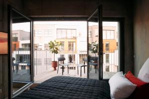 a bedroom with a view of a balcony with a bed at NG19. YOUR INSPIRING HOMEBASE. in Berlin