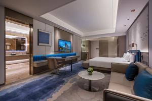 a hotel room with a bed and a desk at Novotel Kunshan Yangcheng Lake in Kunshan