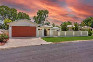 a house with a garage on a street at Trinity Beach Stunner - Tropical Entertainer in Trinity Beach