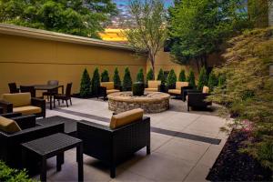 a patio with tables and chairs and a fire pit at Courtyard by Marriott Atlanta Buckhead in Atlanta