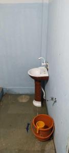 a bathroom with a sink and a toilet at Shree Mangalnath Homestay in Ujjain