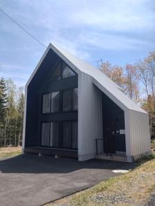 a large white and black building with a garage at Niseko STREAM Villas in Rankoshi