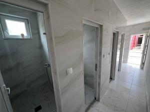 a bathroom with a walk in shower and a glass door at Rural Tourism/Ruralni Turizam Kisin in Trebinje +7 photos