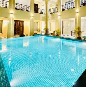 a large swimming pool in a building at Chez Lavania - A Boutique Homestay in Udaipur