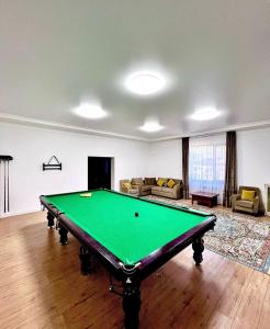 a living room with a pool table in it at Goluboy Zaliv in Borovoye