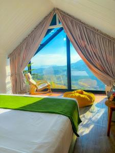 a bedroom with a bed and a large window at The Blackberry Cottage in Nuwara Eliya