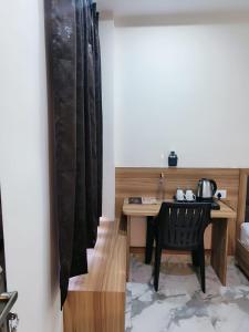 a room with a desk and a table with a chair at NANDI RETREAT HomeStay in Varanasi