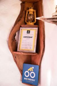 a bottle ofgemini on a wall with a book at Rural Tourism/Ruralni Turizam Kisin in Trebinje