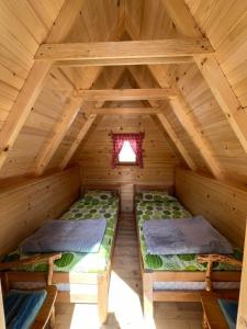a room with two beds in a wooden cabin at Rural Tourism/Ruralni Turizam Kisin in Trebinje