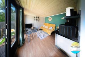 a small living room with a table and a couch at Le Nid des Calanques et son Jacuzzi in Marseille