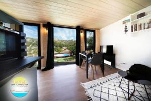 a living room with a table and a large window at Le Nid des Calanques et son Jacuzzi in Marseille +11 photos