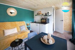 a living room with a couch and a table at Le Nid des Calanques et son Jacuzzi in Marseille