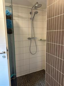 a bathroom with a shower with a glass door at Häuser am See in Königs Wusterhausen