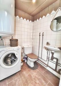 uma casa de banho com uma máquina de lavar roupa e um WC em La Caravelle - Chalet t2 climatisé lit queen size ou twin em Tarbes