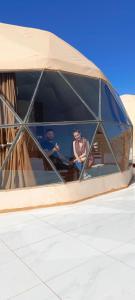 a group of people sitting inside of a building at Rum Green Camp in Wadi Rum